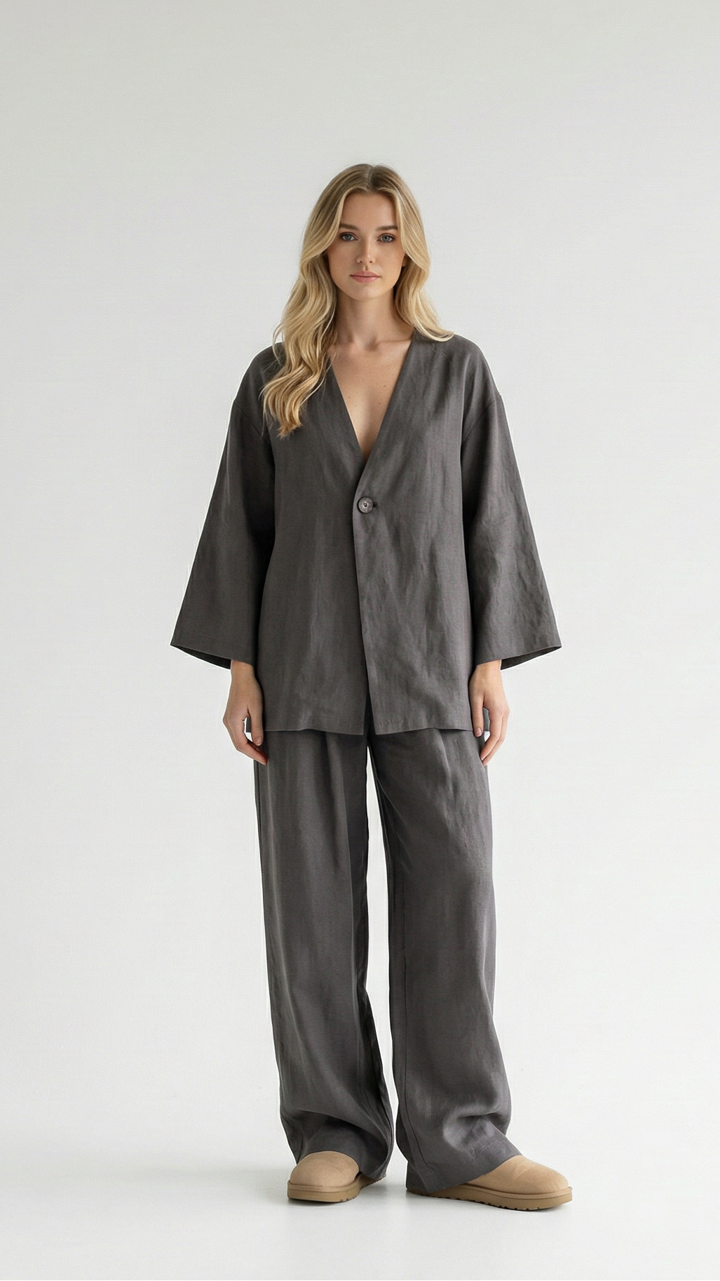 Woman wearing a gray pajama set on a white background